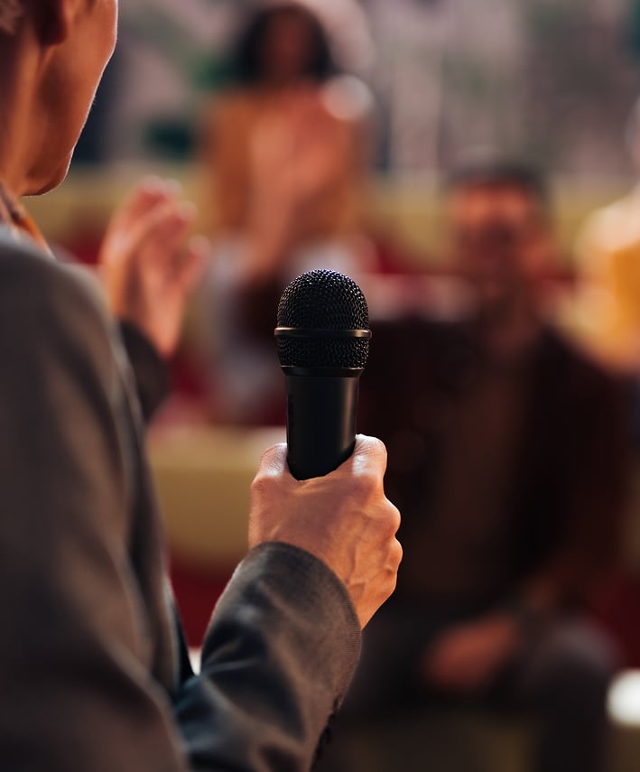mature-speaker-presents-at-conference-with-microph-2026-03-27-00-01-00-utc 1-1 mature-speaker-presents-at-conference-with-microph-2026-03-27-00-01-00-utc 1-1